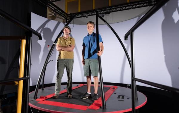 Pawel Golyski and Greg Sawicki (left) with the CAREN (Computer Assisted Rehabilitation Environment) system at Georgia Tech. 