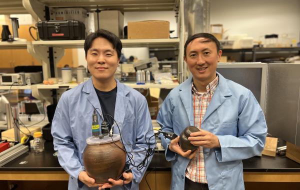 David Hu (right), professor of mechanical engineering, and Soohwan Kim, a second-year Ph.D. student, with the onggi they used in fermentation experiments.