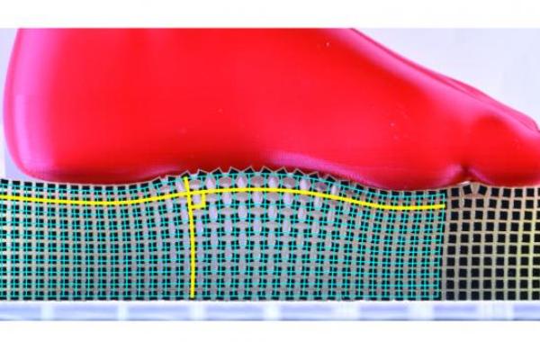 The &ldquo;Rotating Squares” metamaterial deforms conformally, with the blue grid of right angles remaining at right angles after deformation by a foot shaped object. 